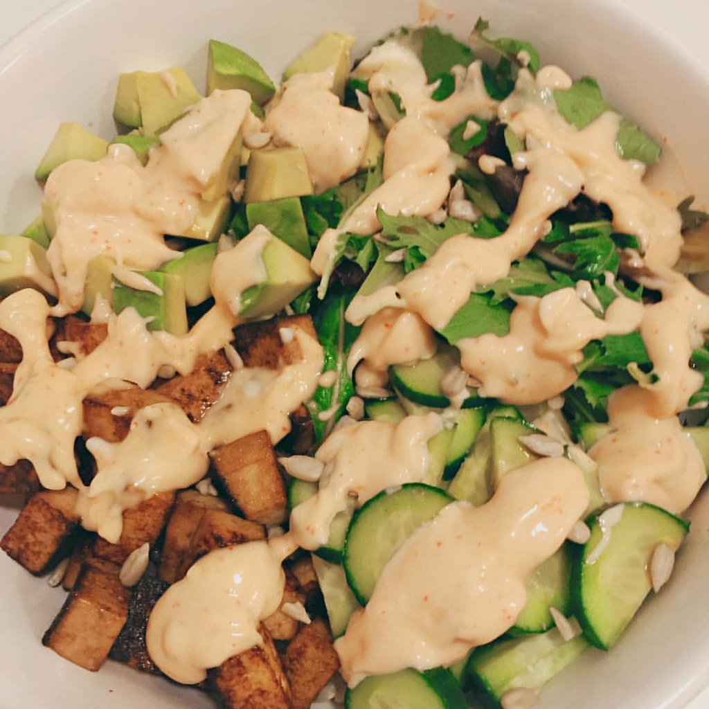 Vegetarian sushi bowl with crispy tofu, avocado, cucumber, greens and spicy mayo