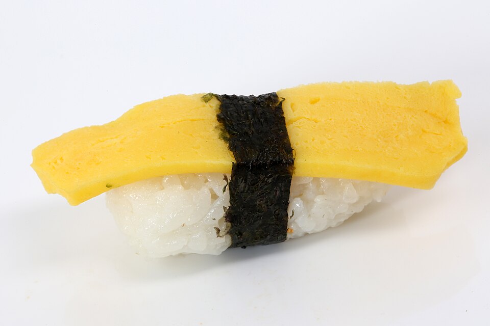 Tamago nigiri: sweet omelette on sushi rice with a nori belt